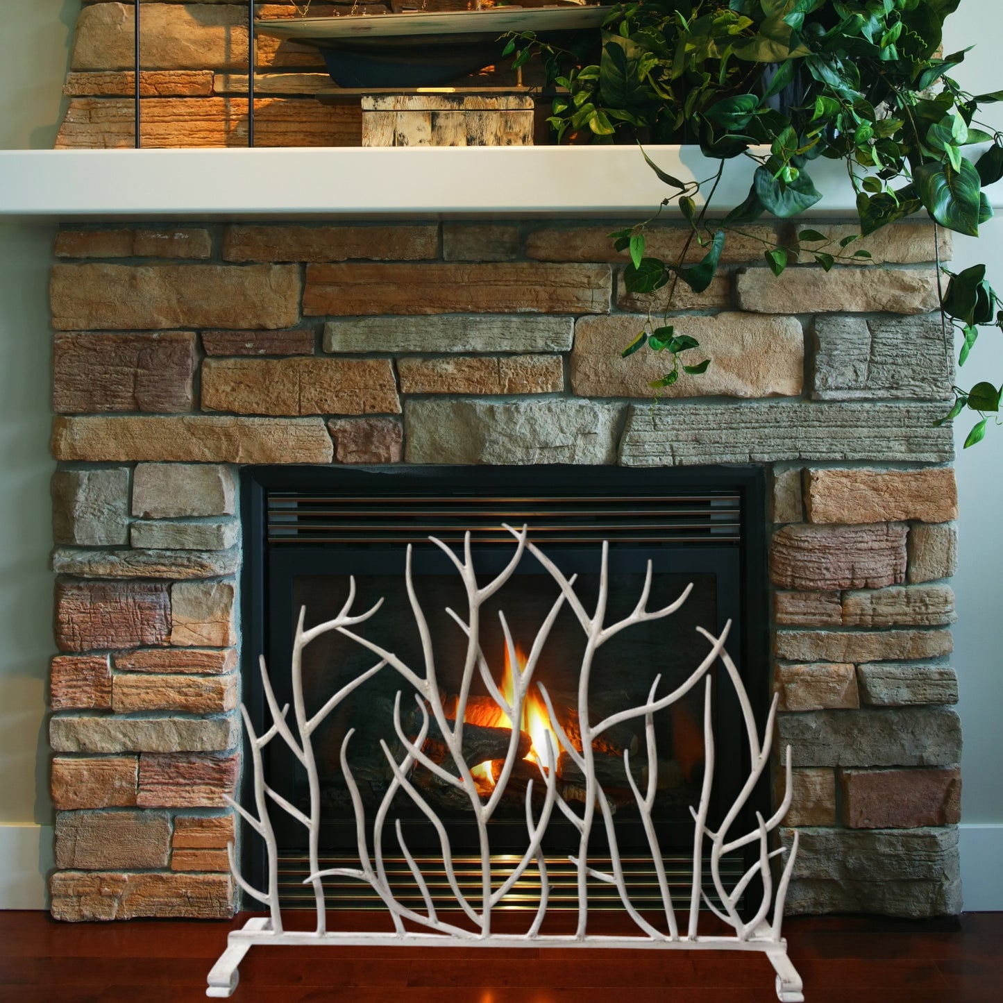 Antique White Iron Twig Decorative Fire Screen in front of fireplace with gas insert | InsideOutCatalog.com