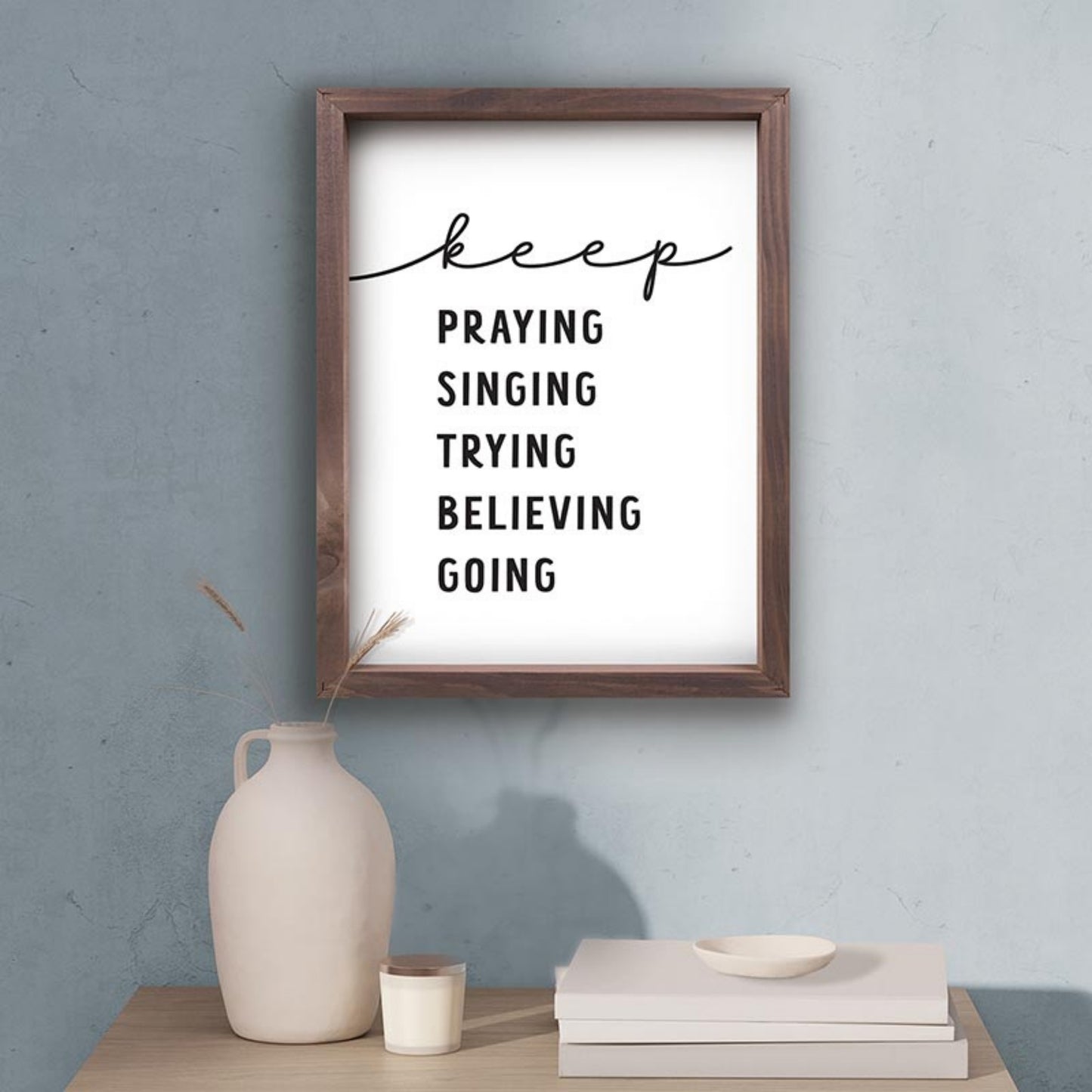 Inspirational Christian Wall Decor - Keep Praying Singing Trying Believing Going shown above a table with home decor | InsideOutCatalog.com
