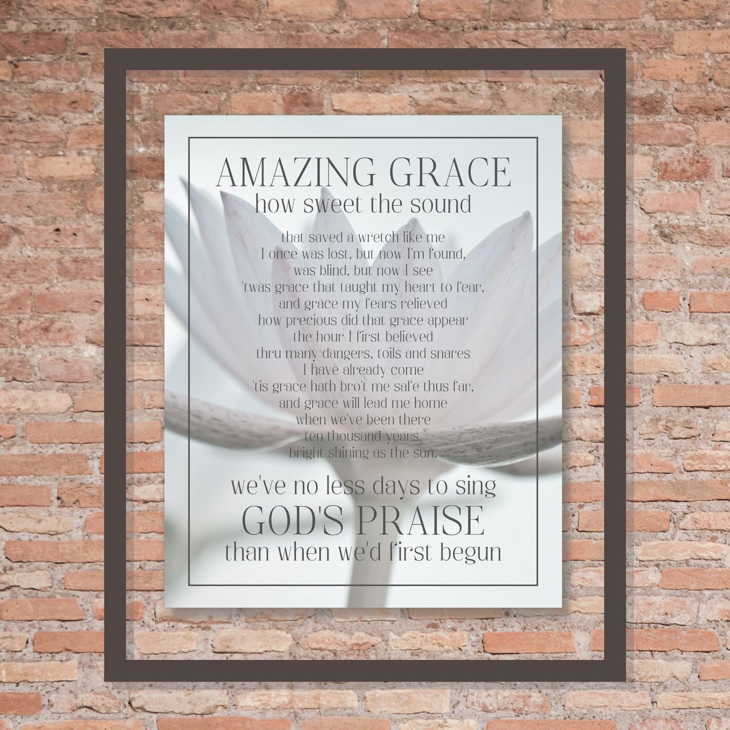 Amazing Grace Song Lyric Wall Art - Inspirational Christian Wall Poster (16x20) shown framed hung on brick wall | InsideOutCatalog.com