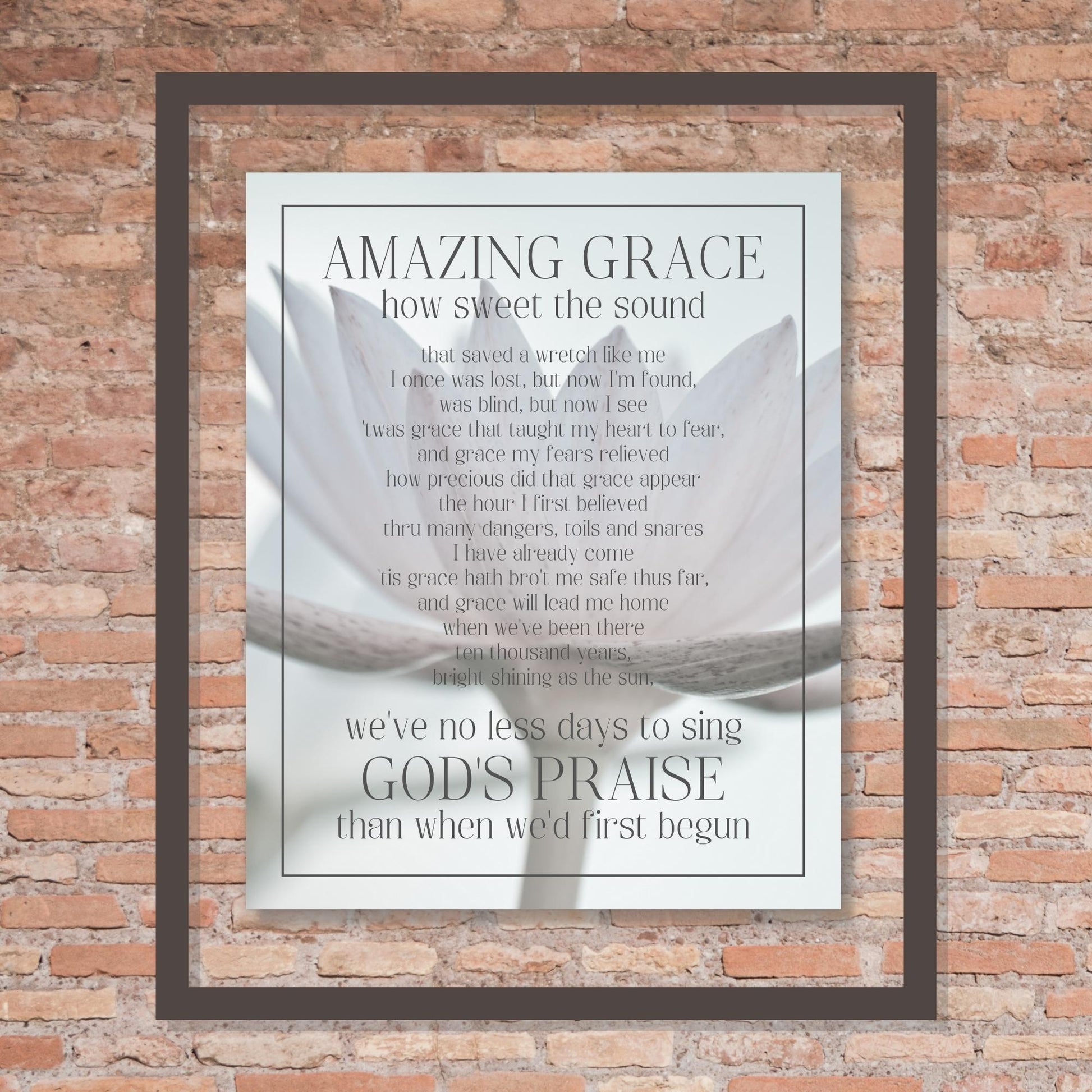 Amazing Grace Song Lyric Wall Art - Inspirational Christian Wall Poster (16x20) shown framed hung on brick wall | InsideOutCatalog.com