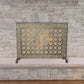Greek Key Designer Fireplace Screen in a Light Burnished Gold Finish - Single Panel Screen in front of stone fireplace | InsideOutCatalog.com