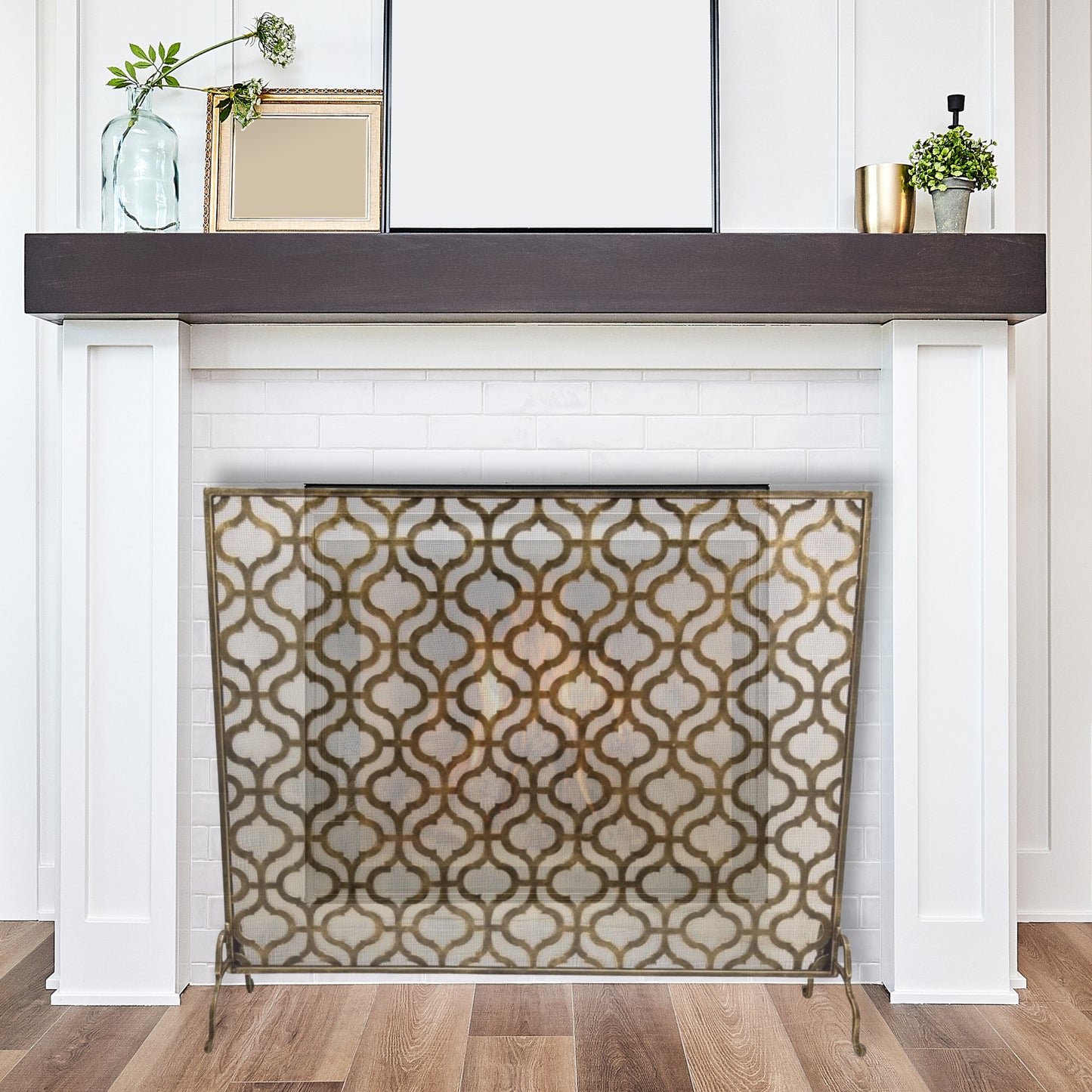 Large Iron Fire Screen with Quadrille Design - Light Burnished Gold Single Panel Fireplace Screen in front of white fireplace with wood mantle | InsideOutCatalog.com