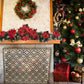 Large Iron Fire Screen with Quadrille Design - Light Burnished Gold Single Panel Fireplace Screen in front of fireplace next to Christmas decorations and tree | InsideOutCatalog.com