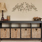Olive Leaf Iron Wall Grille - Red, Green, Gold Metal Wall Decor above Console table with wicker baskets, lamp, and decorative accents | INSIDE OUT - InsideOutCatalog.com