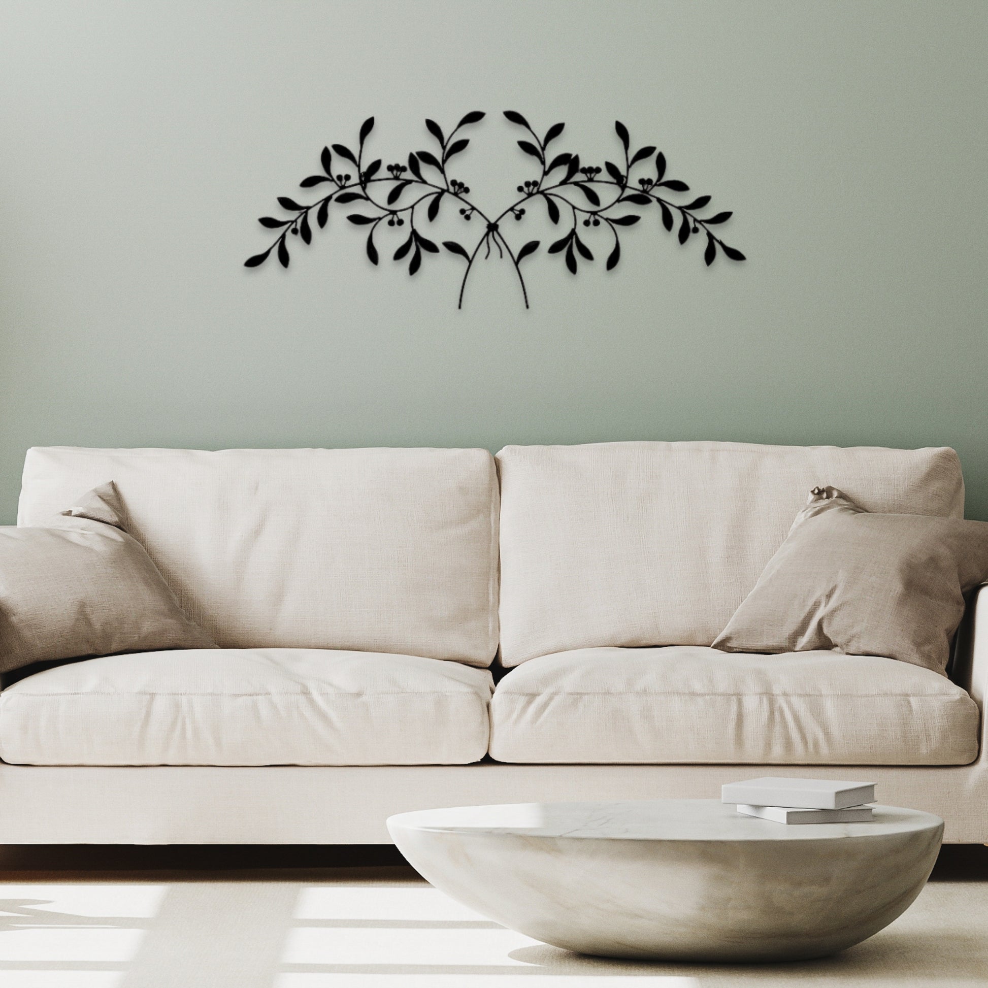 Olive Leaf Iron Wall Grille - Black Metal Wall Decor | Beige sofa with decorative wall art of black leaves on a light sage wall  | INSIDE OUT - InsideOutCatalog.com