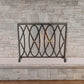 Oval and Diamond Design Single Panel Iron Fire Screen with Mesh - Burnished Gold Iron Screen in front of stone fireplace | InsideOutCatalog.com