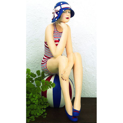 Bathing Beauty Figurine on Beach Ball – Red, White, and Blue Striped Swimsuit, Matching Sun Hat, and Beach Ball | Collectible Figurine | Coastal Living | Beach style home accent | Fourth of July decoration | Americana Figurine | INSIDE OUT | InsideOutCatalog.com