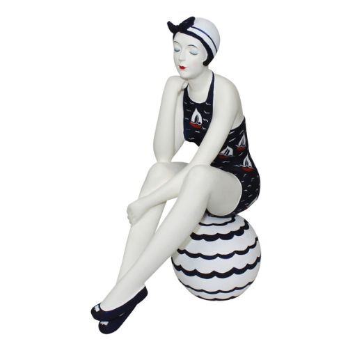 Bathing Beauty Figurine in Navy Blue Swimsuit with Sail Boat Accents Sitting on Beach Ball | INSIDE OUT | InsideOutCatalog.com