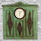 Distressed Blue Carved Wood Wall Decor with Clock shown on white stone wall | INSIDE OUT | InsideOutCatalog.com