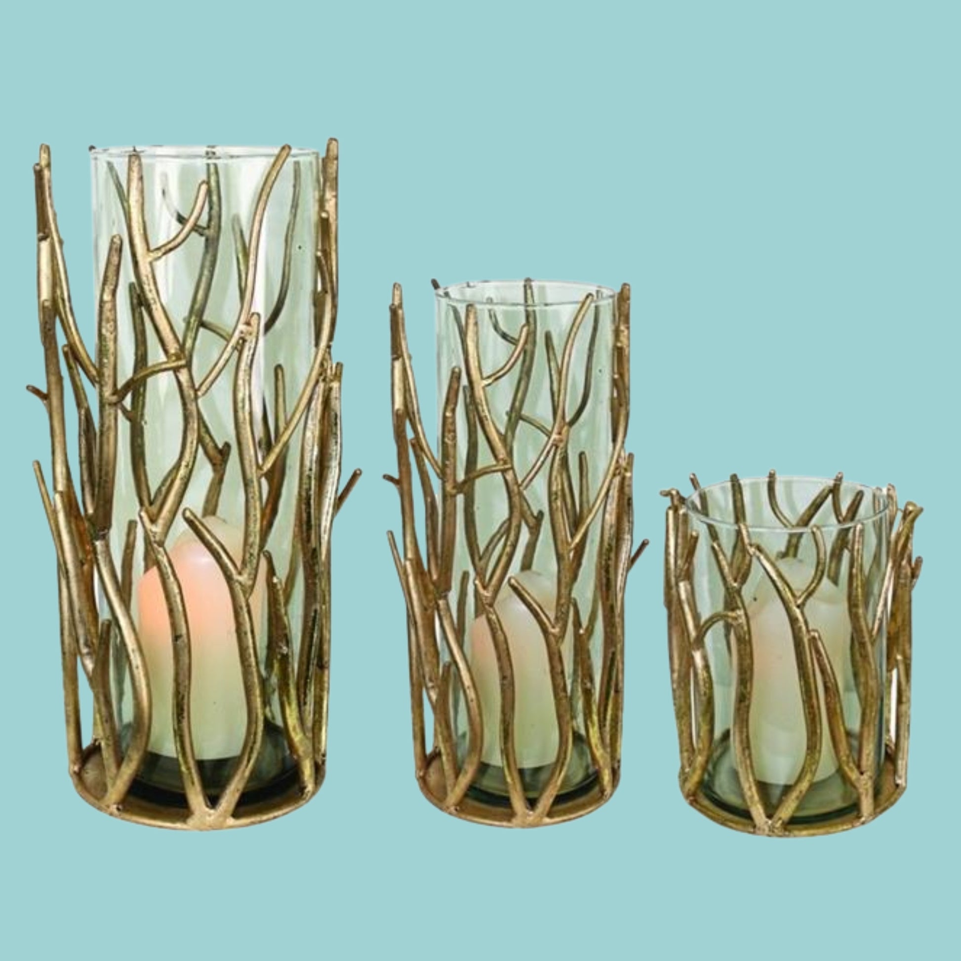 Italian Gold Iron Hurricanes - Twig Accent Iron & Glass Candle Holders - 3 Sizes to Choose From | Shown with a Coastal Blue background for inspiration | Beautiful beach house decor | INSIDE OUT | InsideOutCatalog.com